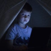 Kind im Dunkeln mit Bildschirm